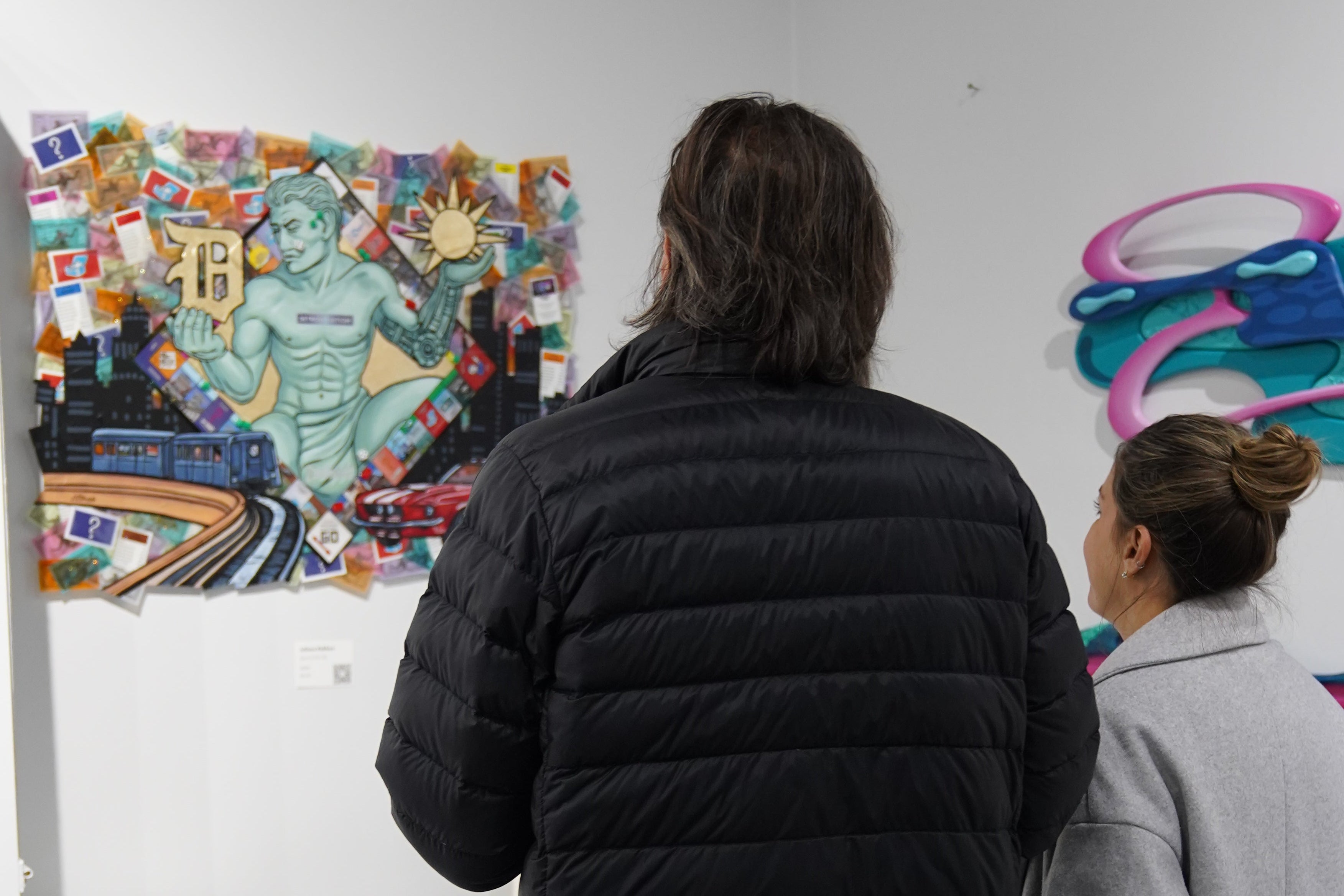 Visitors viewing original canvas artwork created by Just by Juliana at art display